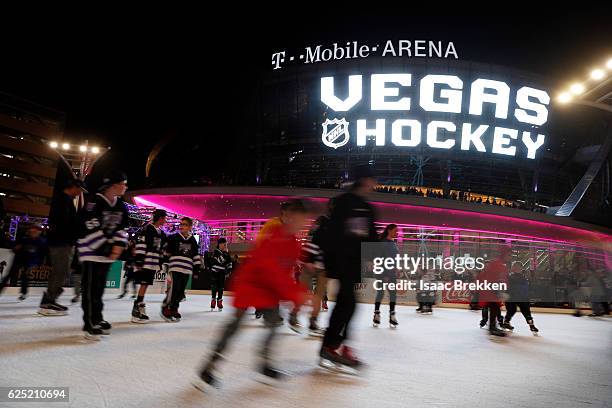 Children skate on an ice rink before the unveiling of the new logo and name for the Vegas Golden Knights in Toshiba Plaza at T-Mobile Arena November...