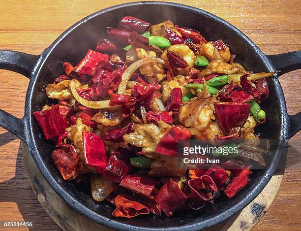 chinese sichuan cuisine, seafood and pork with hot and spicy chilli peppers in iron pot - szechuan cuisine ストックフォトと画像
