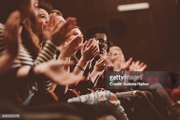 audience applauding in the theater - spectator stock pictures, royalty-free photos & images