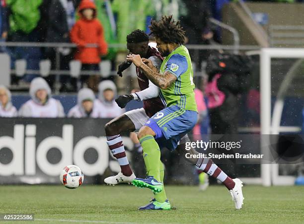 Dominique Badji, left, of the Colorado Rapids battles Roman Torres of the Seattle Sounders for the ball during the first half in the first leg of the...