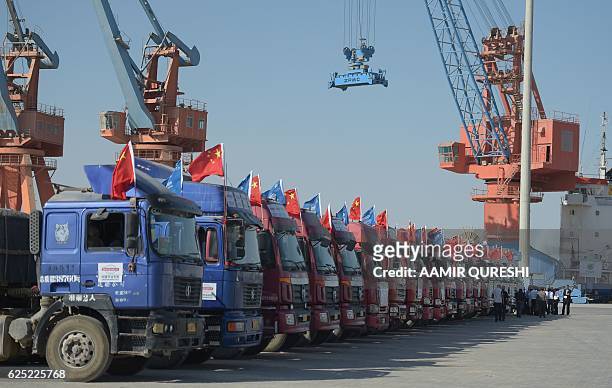 By Ashraf KHAN In this photograph taken on November 13 trucks are seen parked at the Gwadar port, some 700 kms west of Karachi, during the opening...