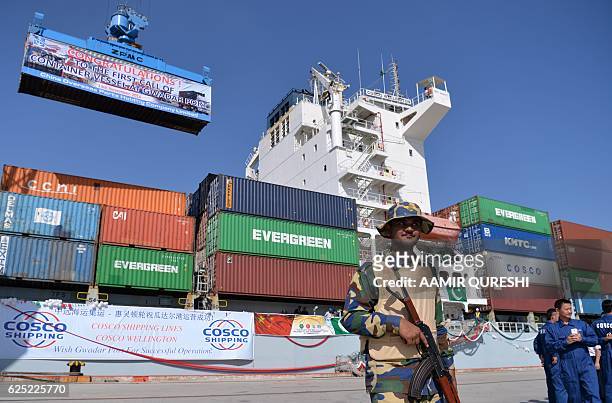 By Ashraf KHAN In this photograph taken on November 13 Pakistani Naval personnel stand guard near a ship carrying containers at the Gwadar port, some...