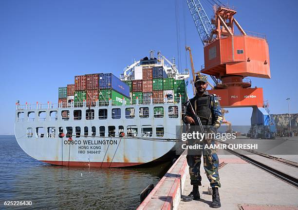 By Ashraf KHAN In this photograph taken on November 13 Pakistani Naval personnel stand guard near a ship carrying containers at the Gwadar port, some...