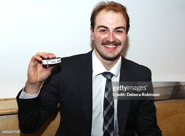 Adam Pelech of the New York Islanders poses with the puck from his first NHL goal following the game against the Anaheim Ducks on November 22, 2016...