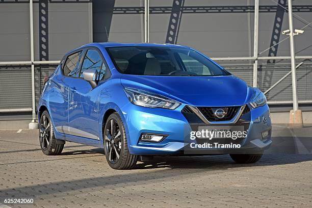 nissan micra on the parking - personenauto stockfoto's en -beelden