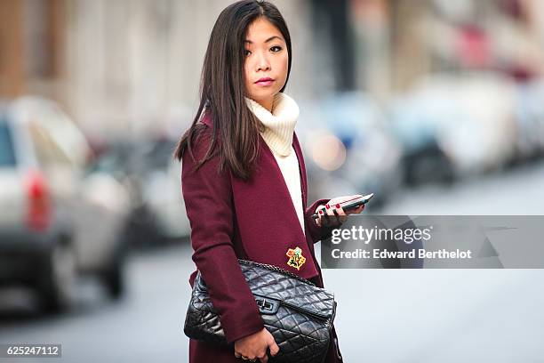 May Berthelot , is wearing New Look babies shoes, a Topshop skirt, New Look purple burgundy coat, a Chanel 2.55 black bag, Chanel bicolor tights with...