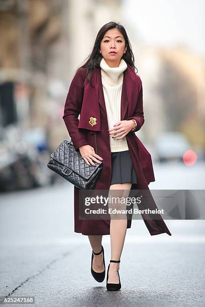 May Berthelot , is wearing New Look babies shoes, a Topshop skirt, New Look purple burgundy coat, a Chanel 2.55 black bag, Chanel bicolor tights with...