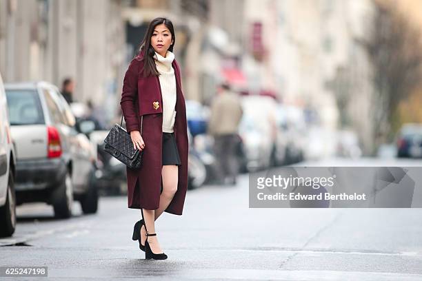 May Berthelot , is wearing New Look babies shoes, a Topshop skirt, New Look purple burgundy coat, a Chanel 2.55 black bag, Chanel bicolor tights with...