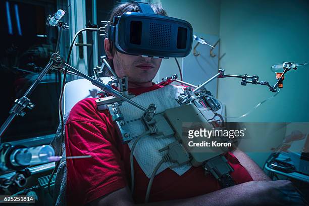 people using virtual reality - tech addiction, futuristic clinic - kult stock-fotos und bilder