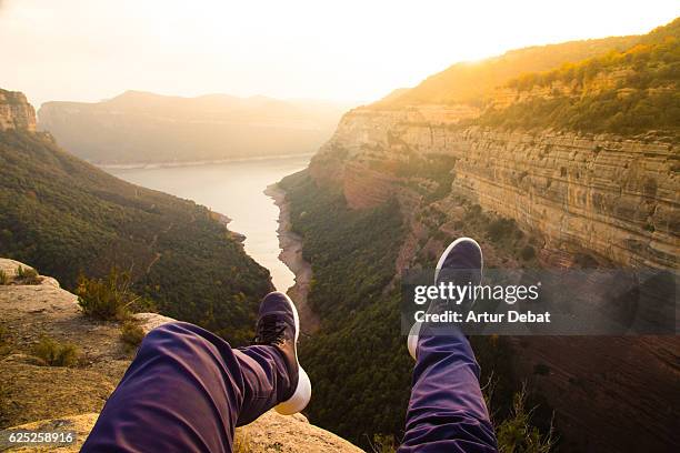 guy from personal perspective with levitating legs flying over the stunning autumn landscape with cliffs and reservoir in the mountains of the catalonia region. - amazing moment in the nature stock-fotos und bilder