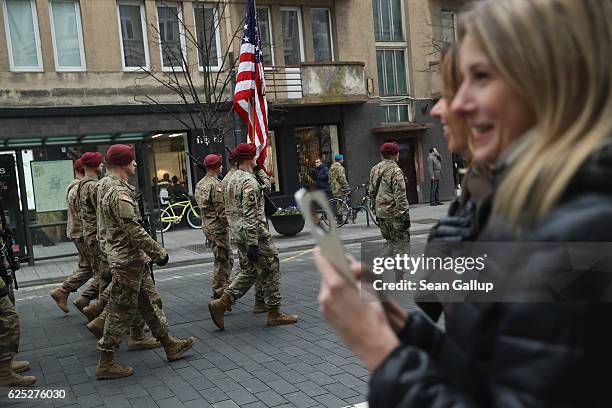 Members of the public look on as soldiers of the U.S. 173rd Airborne Brigade march past in a parade during the Iron Sword military exercises on...