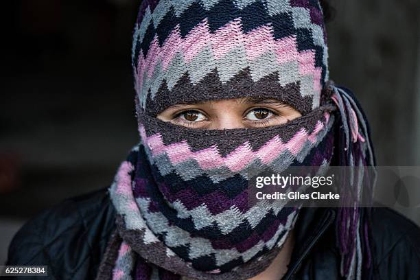 Covered Yazida girl Inside an unfinished school building in the town of Sharya some 20 minutes south of Dahuk. The building now hosts some 70 Yazidi...