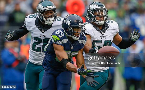 Wide receiver Doug Baldwin of the Seattle Seahawks attempts to make a catch against linebacker Jordan Hicks and safety Jaylen Watkins of the...