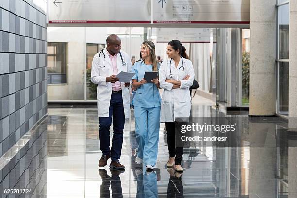 group of doctors talking at the hospital - nurse full length stock pictures, royalty-free photos & images