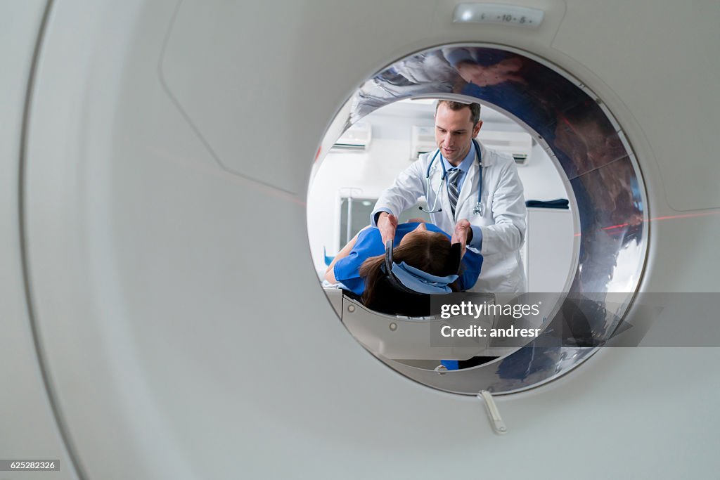 Doctor doing a CTA scan on a patient