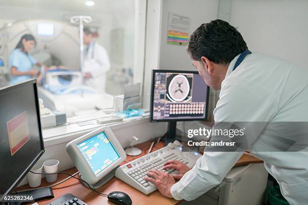 radiologist reading a cat scan - radiotherapy stock pictures, royalty-free photos & images