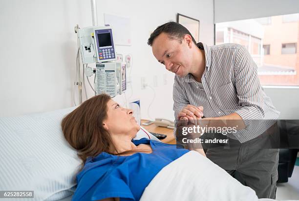 man visiting relative at the hospital - er visit stock pictures, royalty-free photos & images