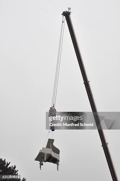 Piano hangs on a crane during the 'Herrgott fuer Anfaenger' set visit in Vienna at Heuriger Sirbu on November 23, 2016 in Vienna, Austria.