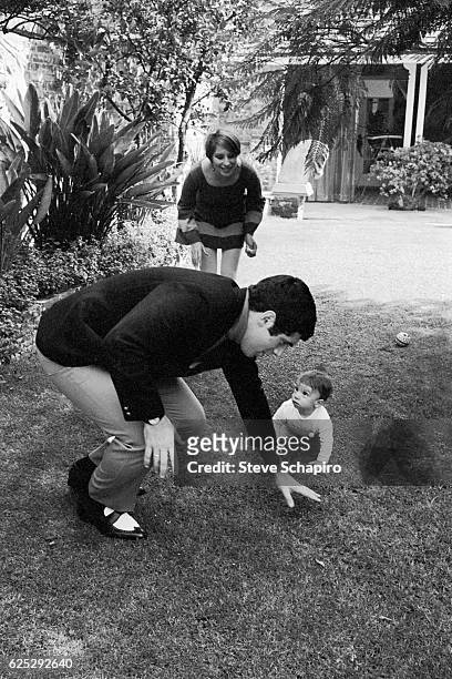Married Americans actor Elliott Gould and actress & musician Barbra Streisand play with their son, Jason, in the garden of their home, Beverly Hills,...
