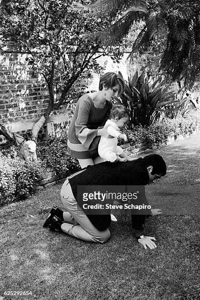 Married Americans actor Elliott Gould and actress & musician Barbra Streisand play with their son, Jason, in the garden of their home, Beverly Hills,...