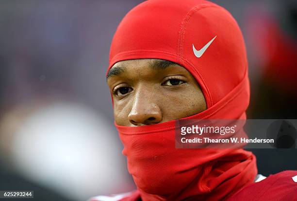 Quinton Patton of the San Francisco 49ers wearing a Nike Pro Combat Hyperwarm Hydropull Hood looks on from the sidelines against the New England...