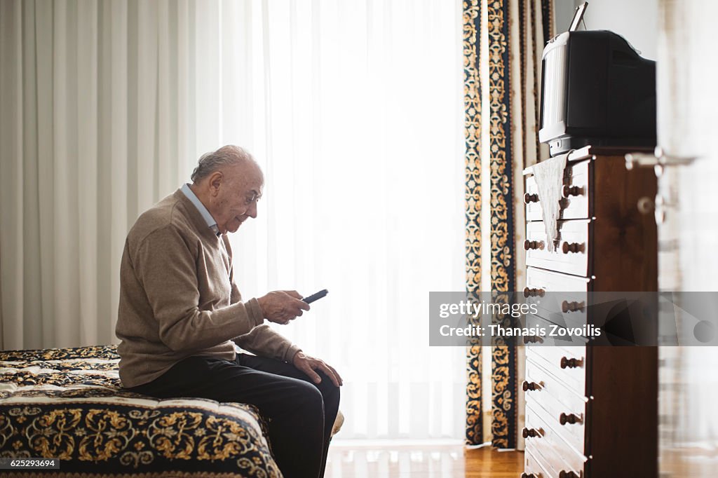 Senior man watching television