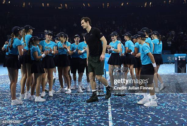 Andy Murray of Great Britain after posing with ball kids following his victory during the Singles Final against Novak Djokovic of Serbia at the O2...