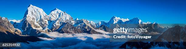 himalayan mountain peaks panorama above the clouds solu khumbu nepal - himalayas stock pictures, royalty-free photos & images