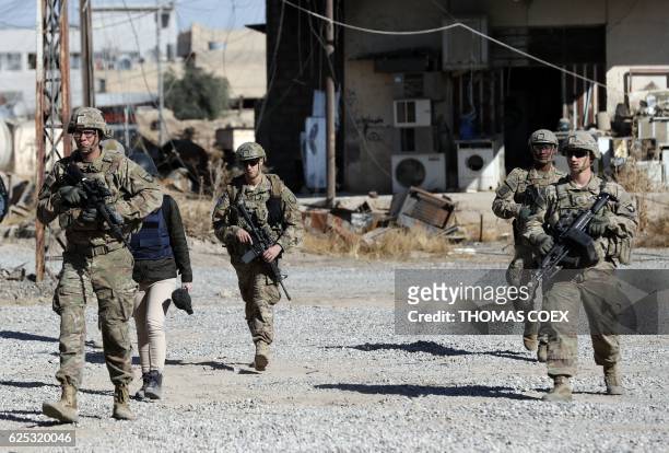 Soldiers patrol near an Iraqi army base on the outskirts of Mosul, on November 23, 2016. Forces battling the Islamic State group in northern Iraq cut...