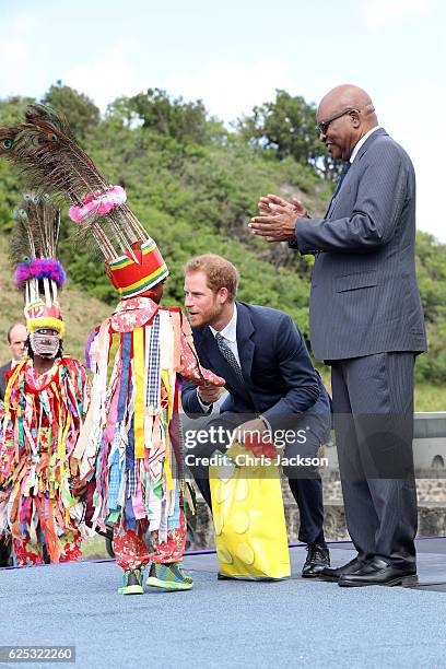 Prince Harry is greeted by cultural dancers at Brimstone Fortress during a youth rally on the fourth day of an official visit on November 23, 2016 in...