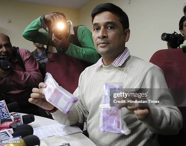 Crime Branch Shailendra Singh Chauhan showing new currency notes of Rs. 746500 recovered from note smugglers on November 23, 2016 in Bhopal, India.