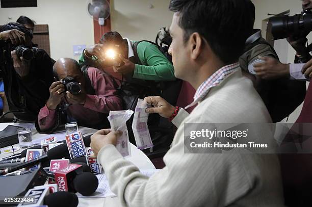 Crime Branch Shailendra Singh Chauhan showing new currency notes of Rs. 746500 recovered from note smugglers on November 23, 2016 in Bhopal, India.