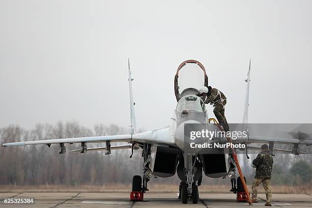 Pilot leaves a Mig-29 fighter jet of the Ukrainian Air Force after a flight during a training session in a military airbase in Vasylkiv village, some...