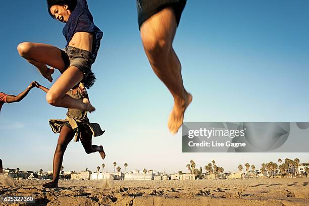 group of friends having fun at the beach - lise gagne stock pictures, royalty-free photos & images