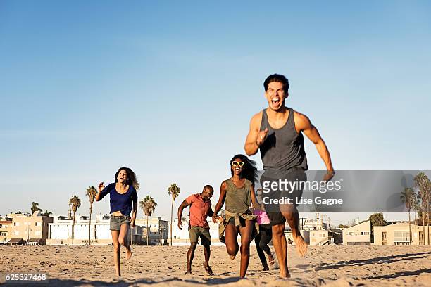 group of friends having fun at the beach - lise gagne stock pictures, royalty-free photos & images