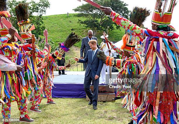 Prince Harry is greeted by cultural dancers as he arrives at Brimstone Fortress during a youth rally on the fourth day of an official visit on...