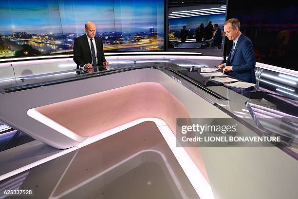 Alain Juppe , mayor of Bordeaux and candidate for the French right-wing presidential primary, and French journalist Julien Arnaud are pictured before...