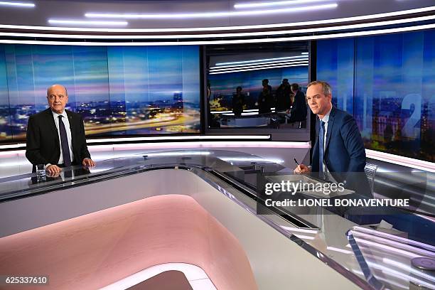 Alain Juppe , mayor of Bordeaux and candidate for the French right-wing presidential primary, and French journalist Julien Arnaud are pictured before...