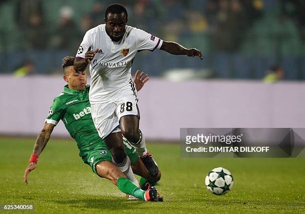 Basel's Ivorian forward Seydou Doumbia vies with Ludogorets' midfielder Madagascan Anicet Abel during the UEFA Champions League group A football...