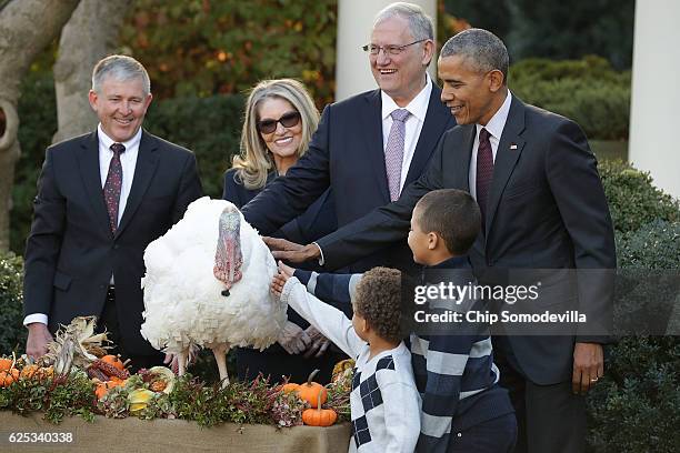 President Barack Obama pardons the National Thanksgiving Turkey, 'Tot,' with his nephews Aaron and Austin Robinson and National Turkey Federation...