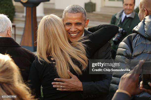 President Barack Obama embraces sister-in-law Kelly Robinson after he pardoned the National Thanksgiving Turkey in a ceremony in the Rose Garden at...