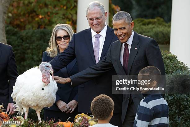 President Barack Obama pardons the National Thanksgiving Turkey, 'Tot,' with his nephews Aaron and Austin Robinson and National Turkey Federation...