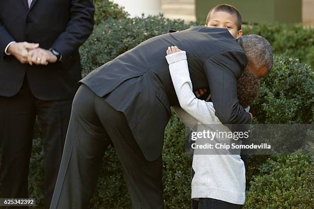 President Barack Obama embraces his nephews Aaron and Austin Robinson after he pardoned the National Thanksgiving Turkey in a ceremony in the Rose...