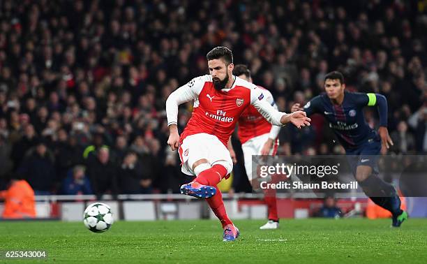 Olivier Giroud of Arsenal scores his sides first goal from the penalty spot during the UEFA Champions League Group A match between Arsenal FC and...