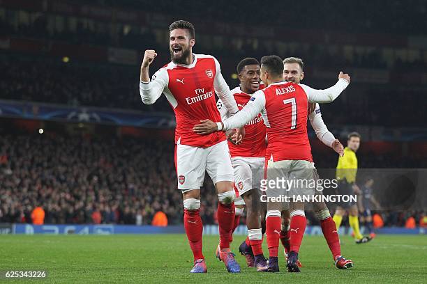 Arsenal's French striker Olivier Giroud celebrates after Paris Saint-Germain's Italian midfielder Marco Verratti scored an own goal for Arsenal's...