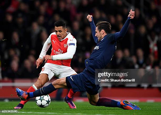 Alexis Sanchez of Arsenal is fouled by Grzegorz Krychowiak of PSG and a penalty is awarded to Arsenal during the UEFA Champions League Group A match...