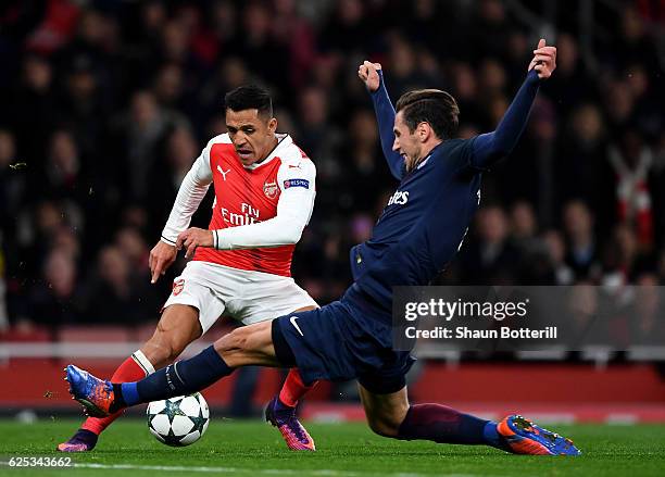 Alexis Sanchez of Arsenal is fouled by Grzegorz Krychowiak of PSG and a penalty is awarded to Arsenal during the UEFA Champions League Group A match...