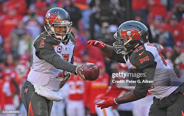 Quarterback Jameis Winston of the Tampa Bay Buccaneers hands the ball off to running back Peyton Barber against the Kansas City Chiefs during the...