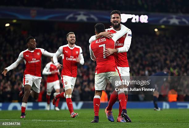 Alexis Sanchez of Arsenal and Olivier Giroud of Arsenal celebrate after their side score their second goal through a own goal by Marco Verratti of...