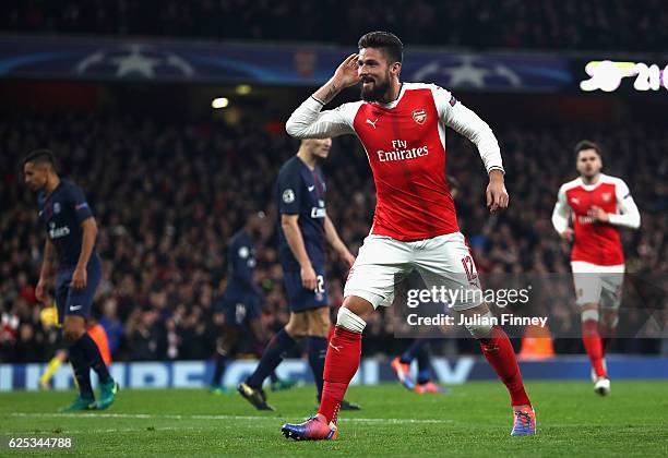Olivier Giroud of Arsenal celebrates his sides second goal after Marco Verratti of PSG scored a own goal during the UEFA Champions League Group A...